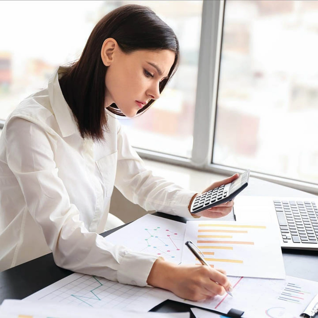 Financial services professional reviewing client data on laptop