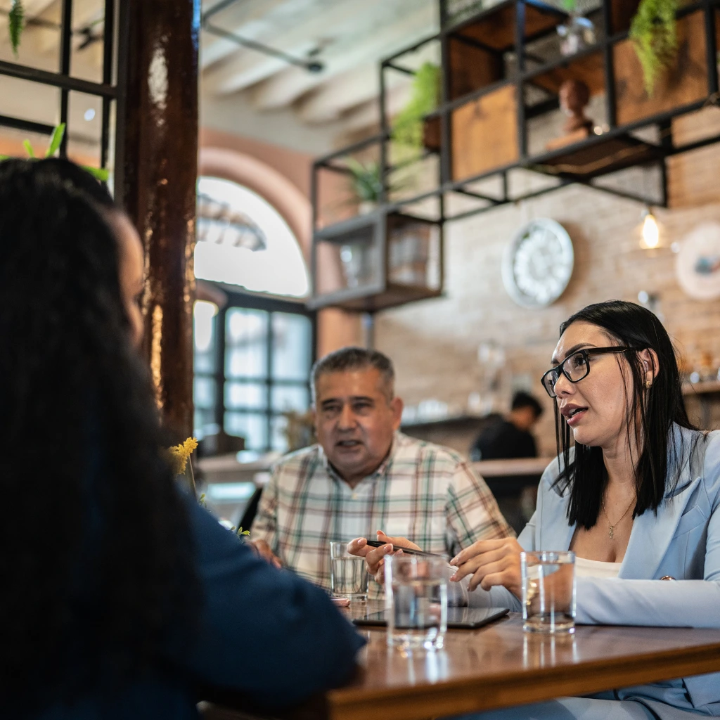 Hospitality venue guests meeting at a restaurant table