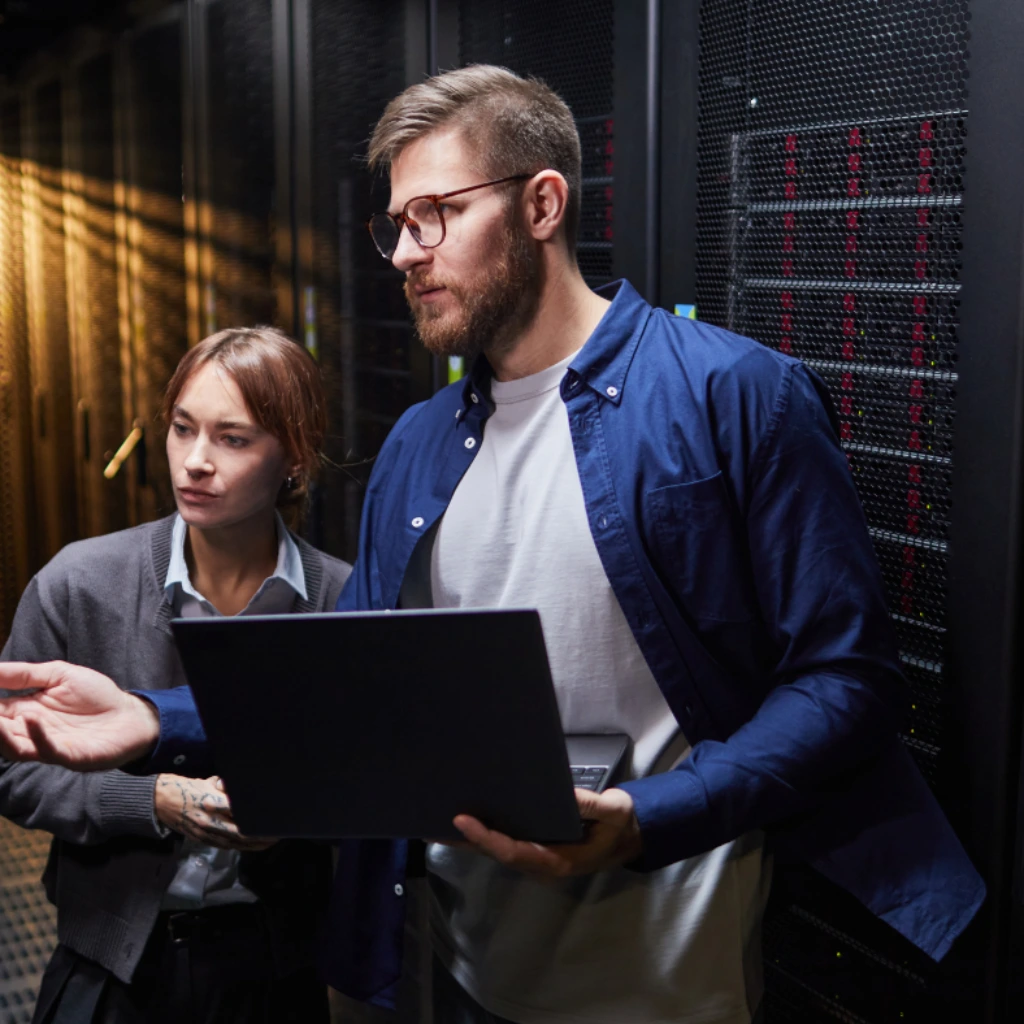 IT support technicians reviewing systems in a server room
