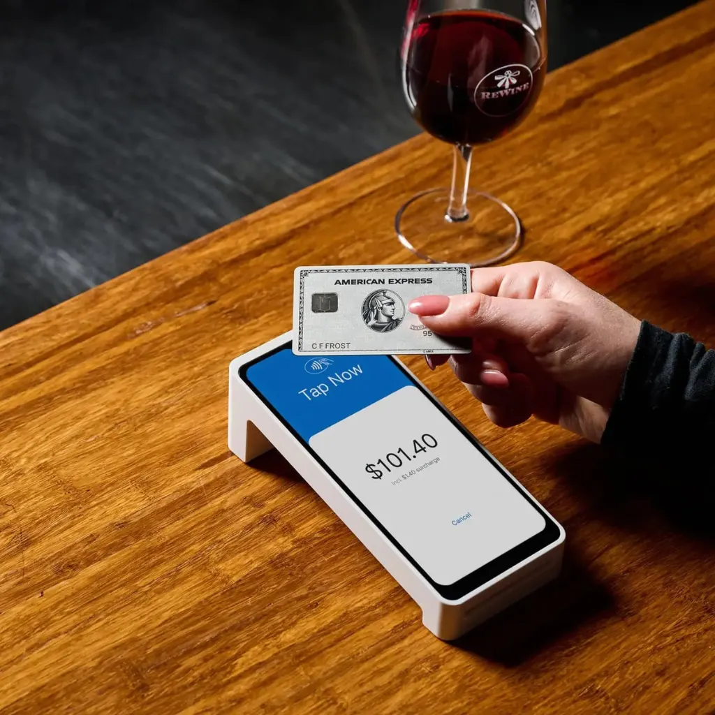 Contactless card payment on a POS terminal at a restaurant bar