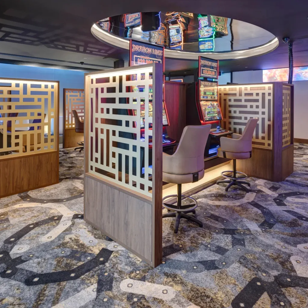 Modern gaming room with partitioned poker machine stations in a club