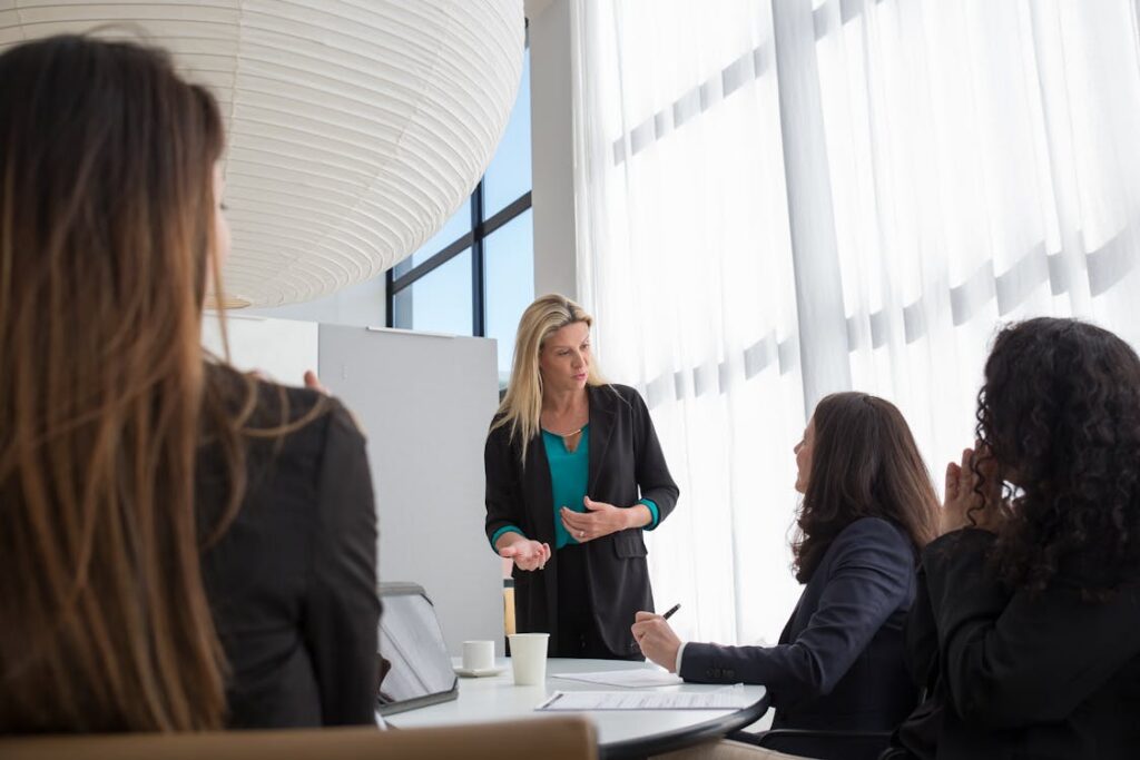 Colleagues meeting around a table in an office — IT compliance and support for Australian not-for-profits